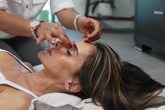 Acupuncture treatment person holding woman nose